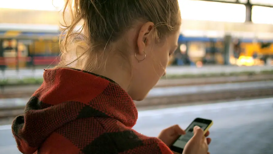 Traveller checking her phone on a city street